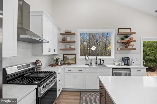 a kitchen with stainless steel appliances a sink stove and refrigerator