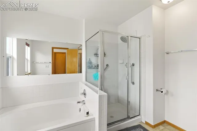 a bathroom with a bathtub and a shower