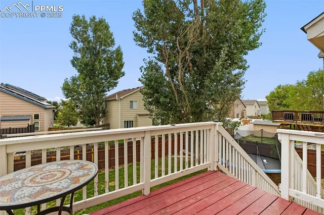a view of a chair and table on the deck