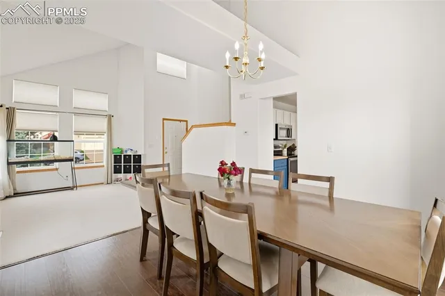 a view of a dining room with furniture and a chandelier
