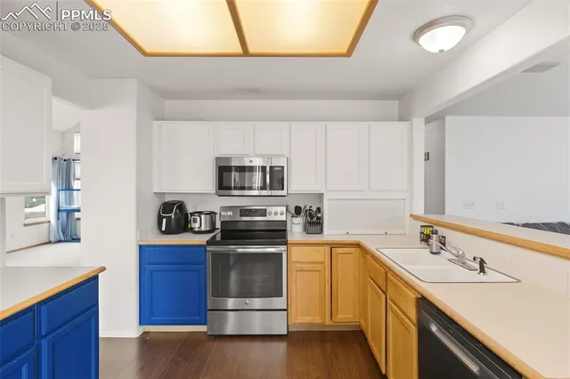 a kitchen with stainless steel appliances a sink stove and cabinets