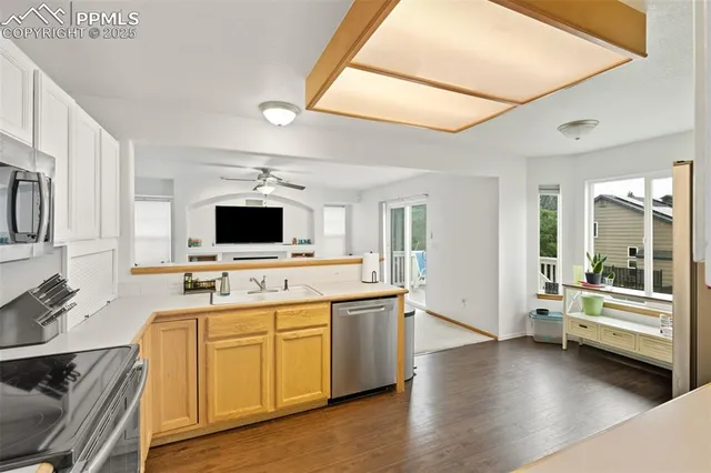 a large white kitchen with a stove and a sink