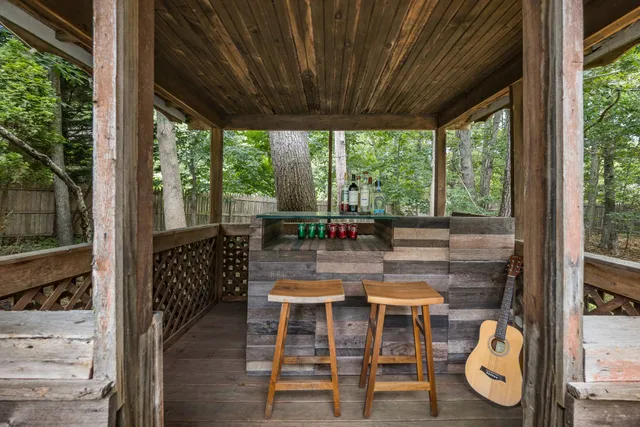 a backyard of a house with table and chairs