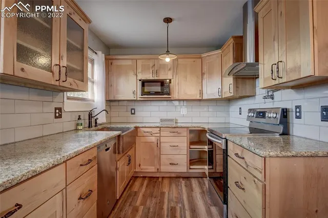 a kitchen with stainless steel appliances granite countertop a sink stove and microwave