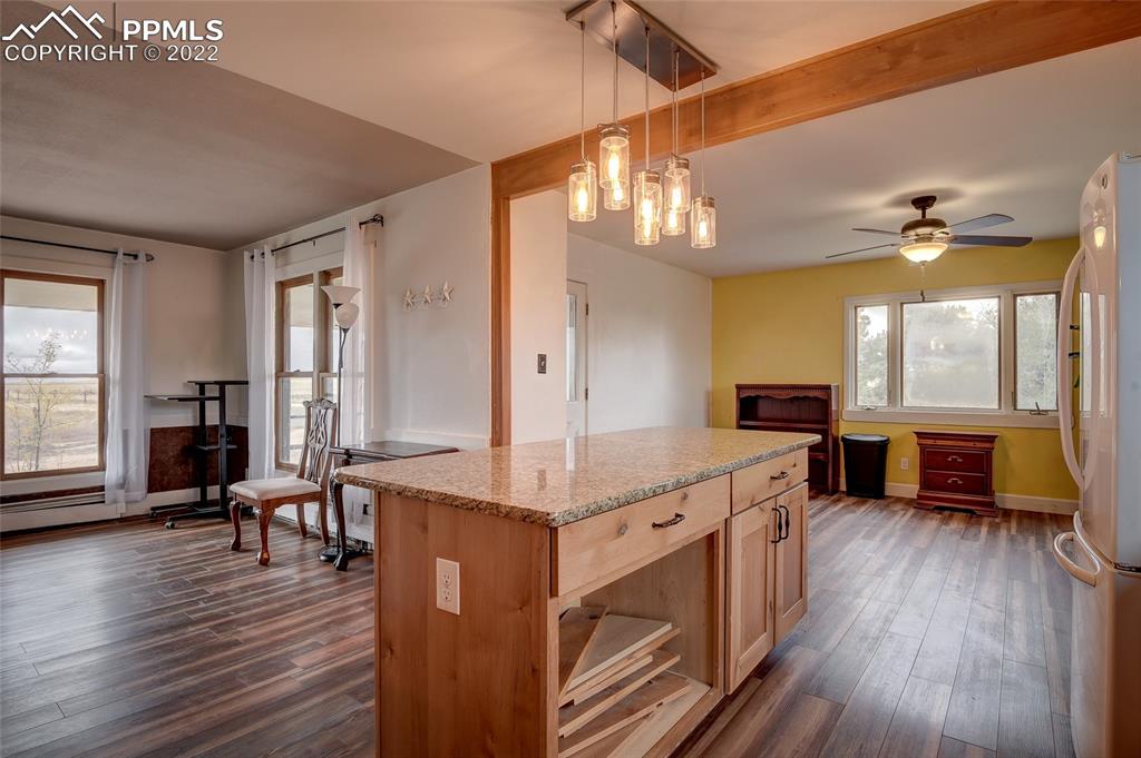 37550 Highway 94 Yoder, CO 80864 - Photo 19 of 39 a view of a kitchen counter top space with furniture and wooden floor
