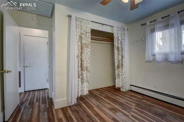 a view of a livingroom with wooden floor and staircase