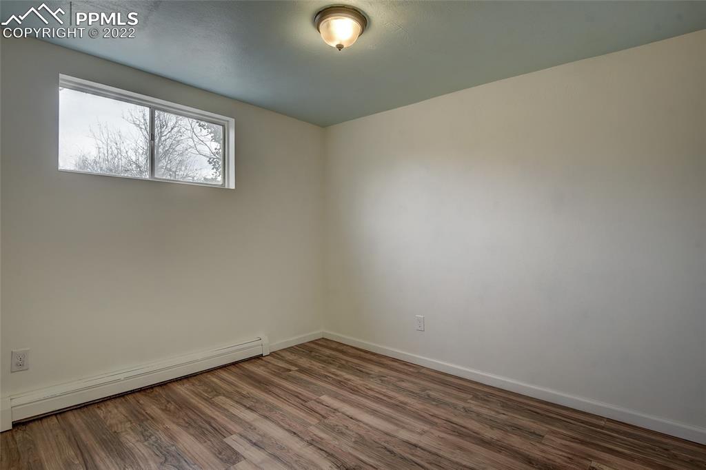 37550 Highway 94 Yoder, CO 80864 - Photo 24 of 39 an empty room with wooden floor and windows