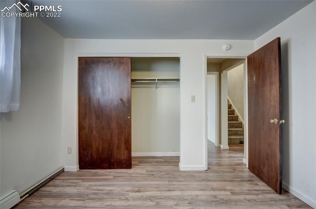 37550 Highway 94 Yoder, CO 80864 - Photo 28 of 39 an empty room with wooden floor and closet