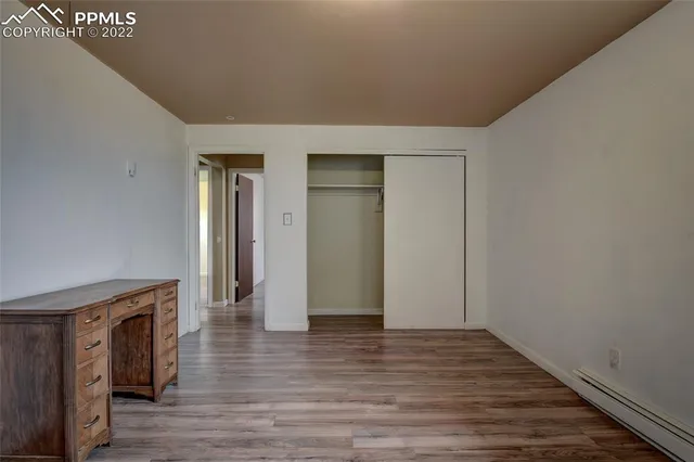 a view of an empty room with wooden floor