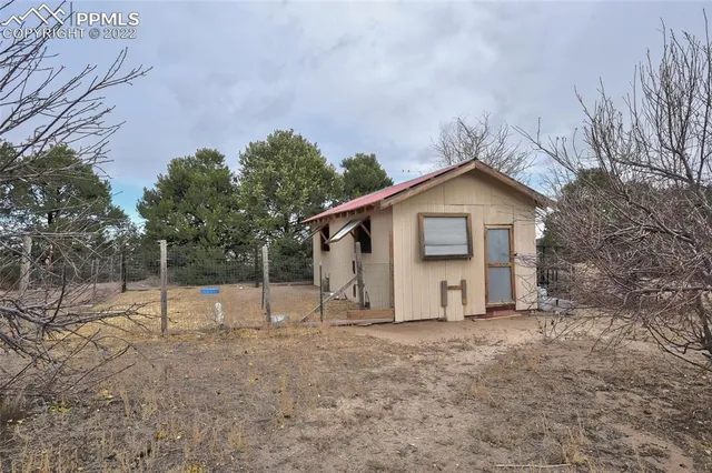 a view of backyard with wooden fence