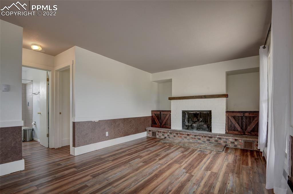 37550 Highway 94 Yoder, CO 80864 - Photo 5 of 39 a view of empty room with wooden floor and fireplace