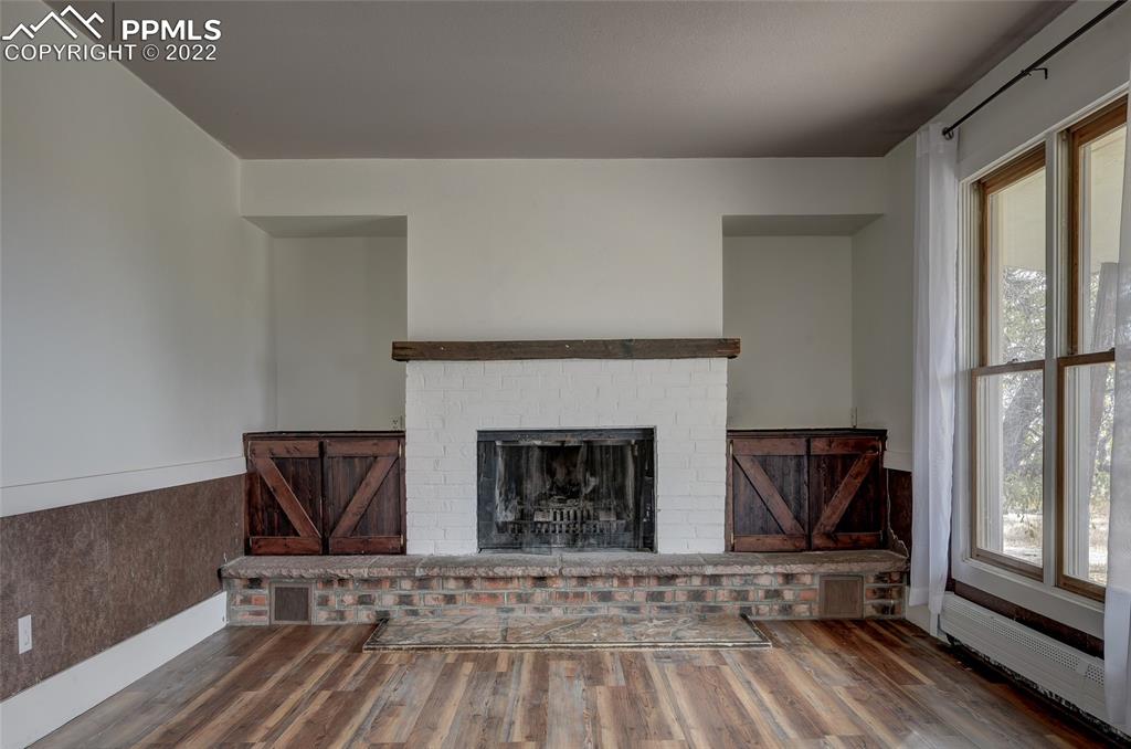 37550 Highway 94 Yoder, CO 80864 - Photo 6 of 39 a living room with furniture and a fireplace