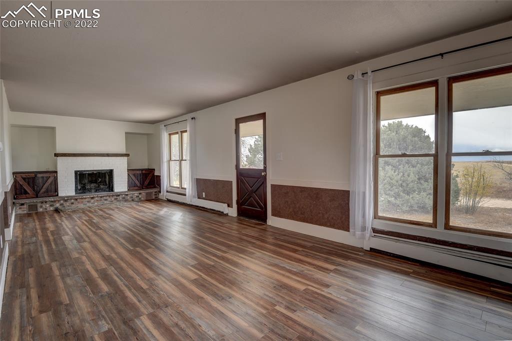 37550 Highway 94 Yoder, CO 80864 - Photo 7 of 39 a view of empty room with wooden floor and fireplace