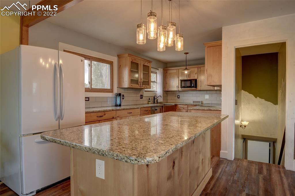 37550 Highway 94 Yoder, CO 80864 - Photo 10 of 39 a kitchen with stainless steel appliances granite countertop a sink refrigerator and cabinets