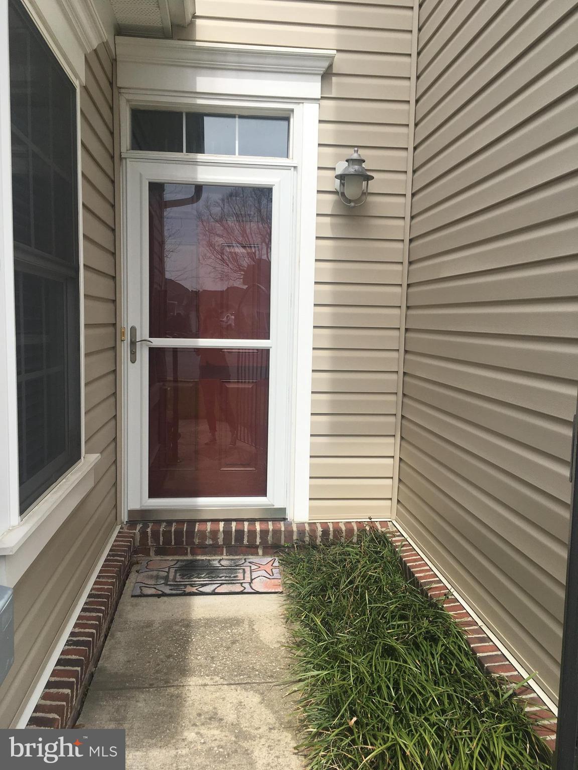 14162 Foxhall Road, Unit 4 Dowell, MD 20629 - Photo 2 of 24 a view of a door of a house with a small window