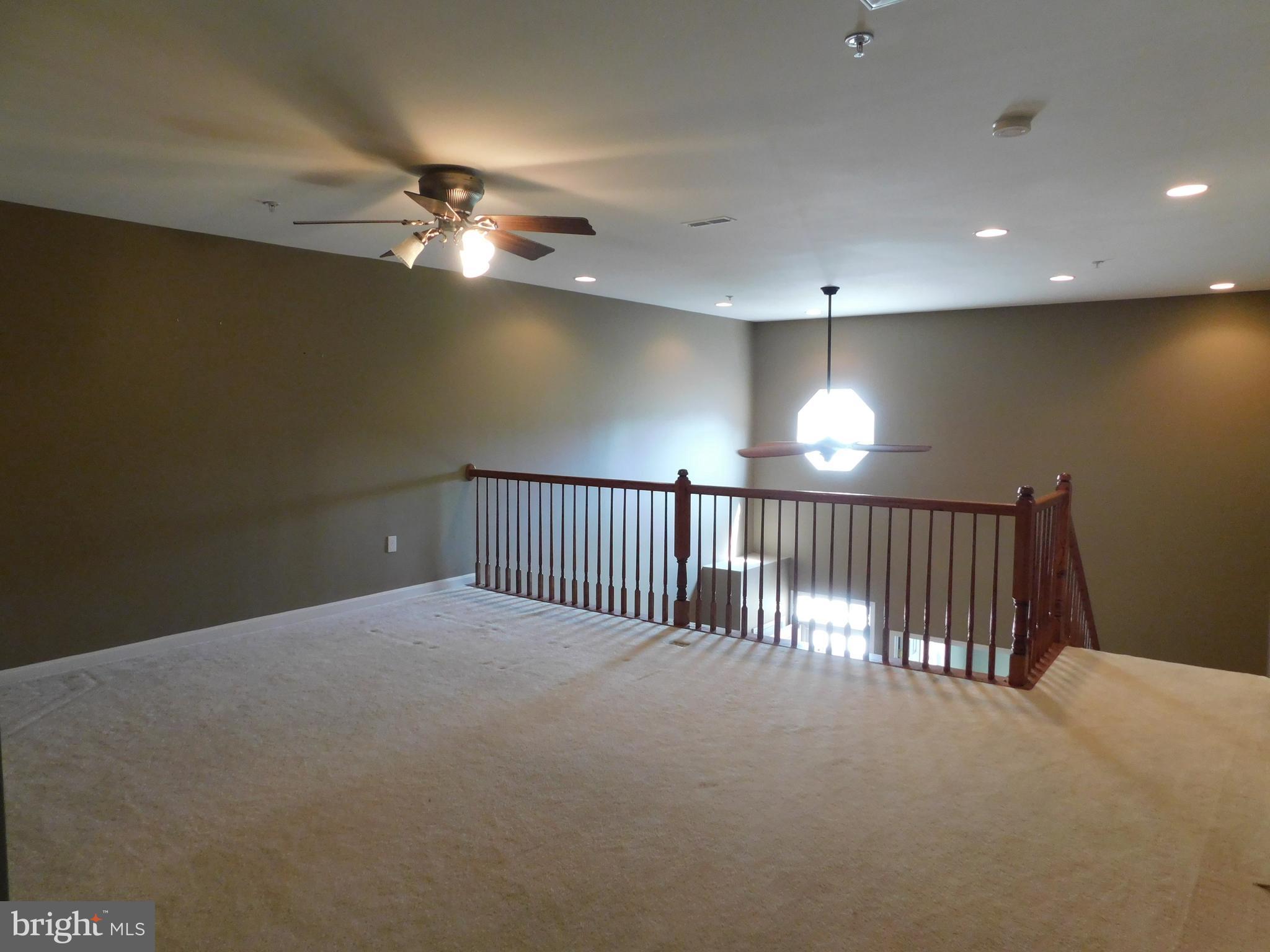 14162 Foxhall Road, Unit 4 Dowell, MD 20629 - Photo 14 of 24 a view of staircase and hallway with a projector