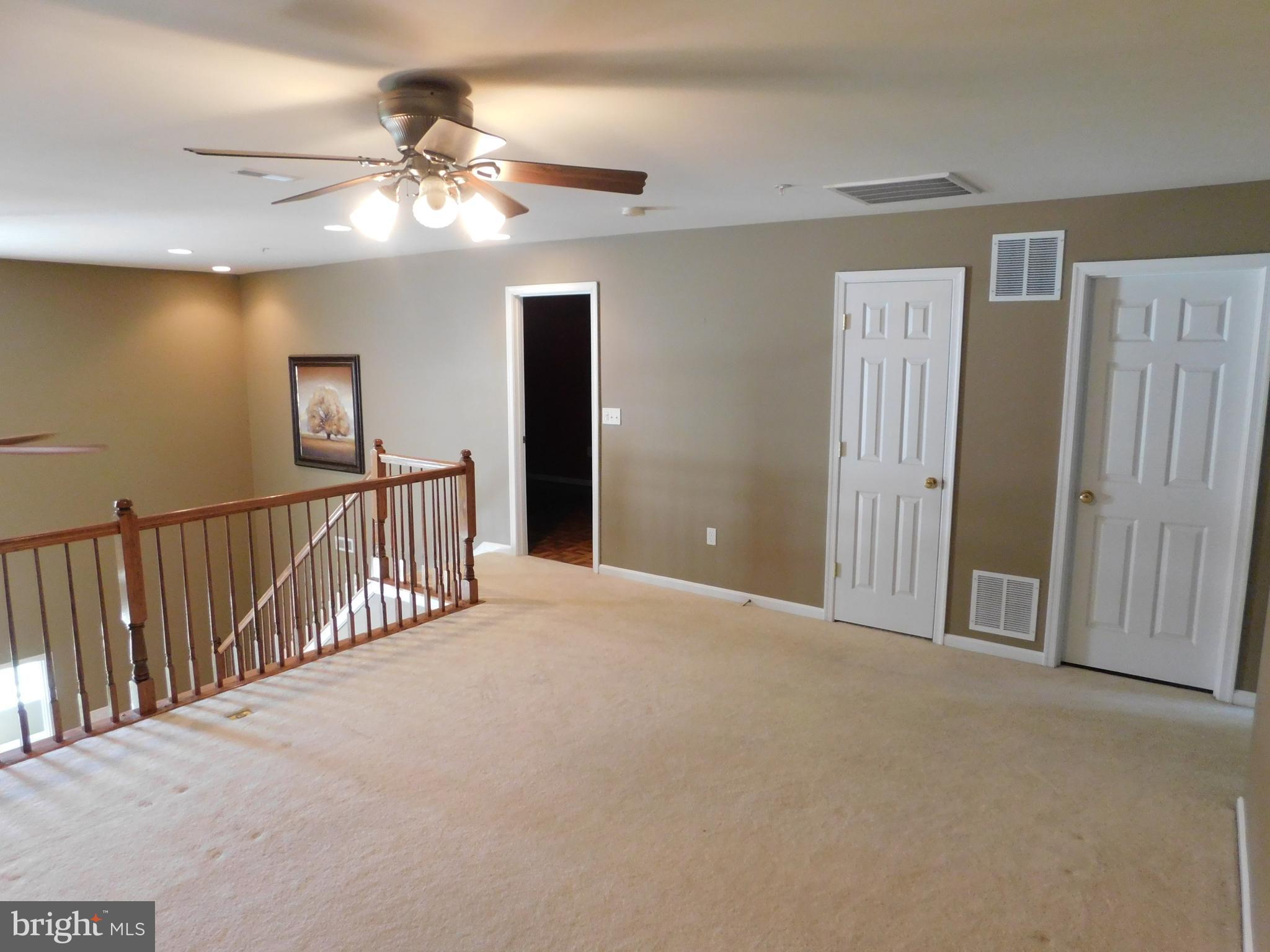 14162 Foxhall Road, Unit 4 Dowell, MD 20629 - Photo 15 of 24 a view of a hallway with a chandelier fan and a livingroom