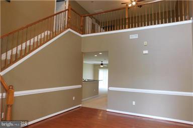 14162 Foxhall Road, Unit 4 Dowell, MD 20629 - Photo 3 of 24 a view of a room with wooden floor