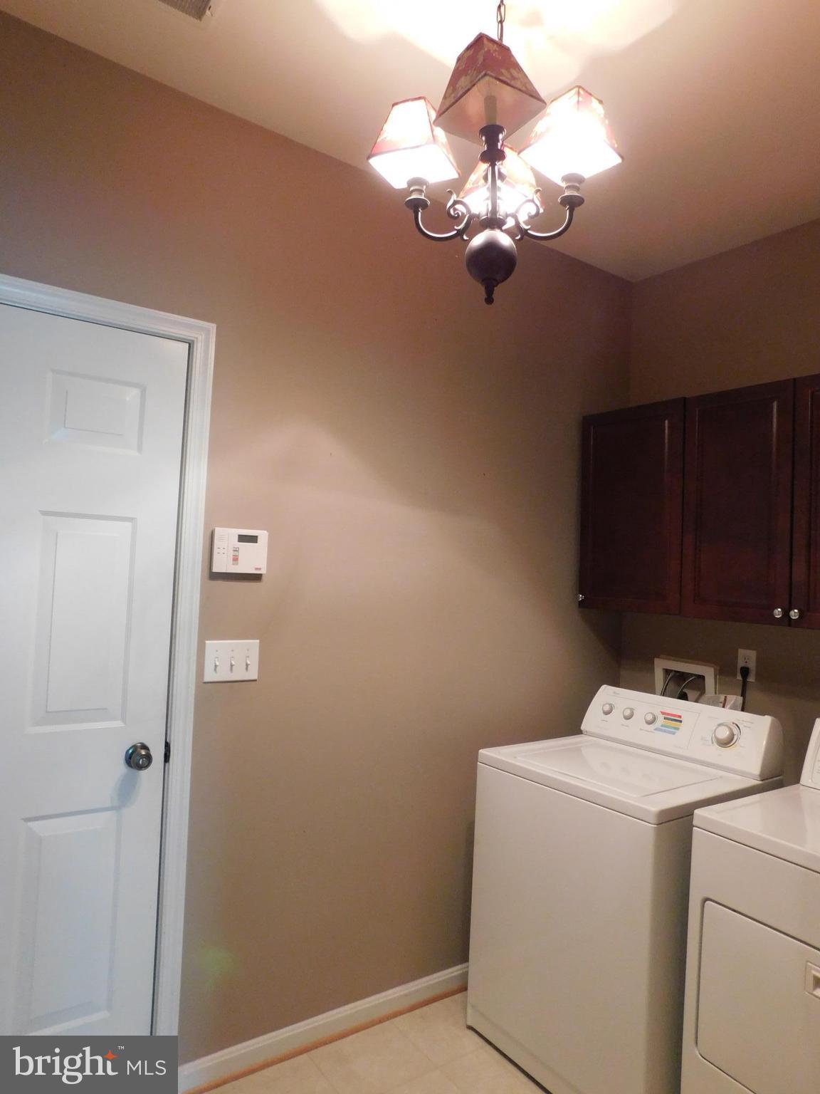 14162 Foxhall Road, Unit 4 Dowell, MD 20629 - Photo 8 of 24 a bathroom with a sink a light fixture and a stove