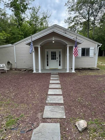 a living room with furniture and potted plants