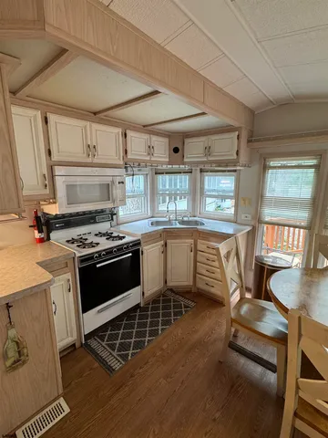 a kitchen with a stove a sink and a microwave