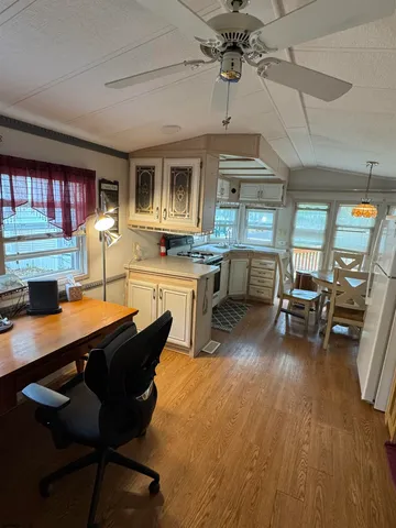 a view of a dining room with furniture window and wooden floor