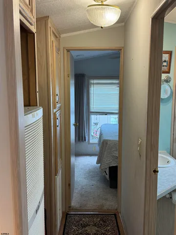 a view of hallway with shower and closet