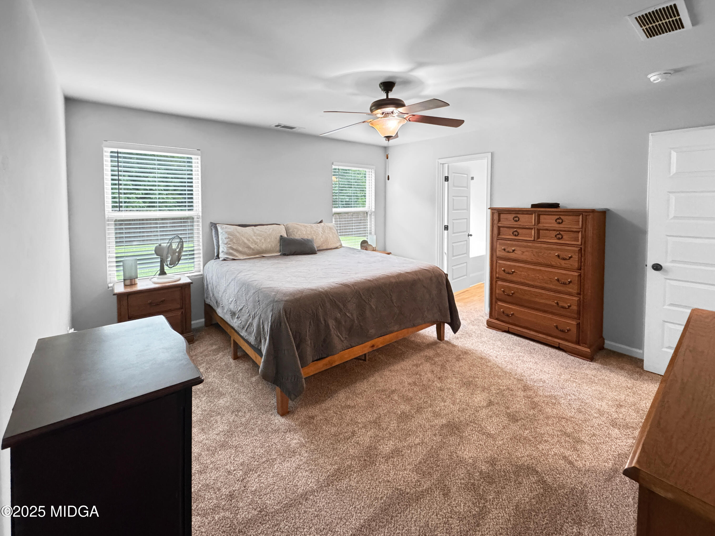 837 Weldon Road Forsyth, GA 31029 - Photo 11 of 24 a bedroom with a bed and a dresser