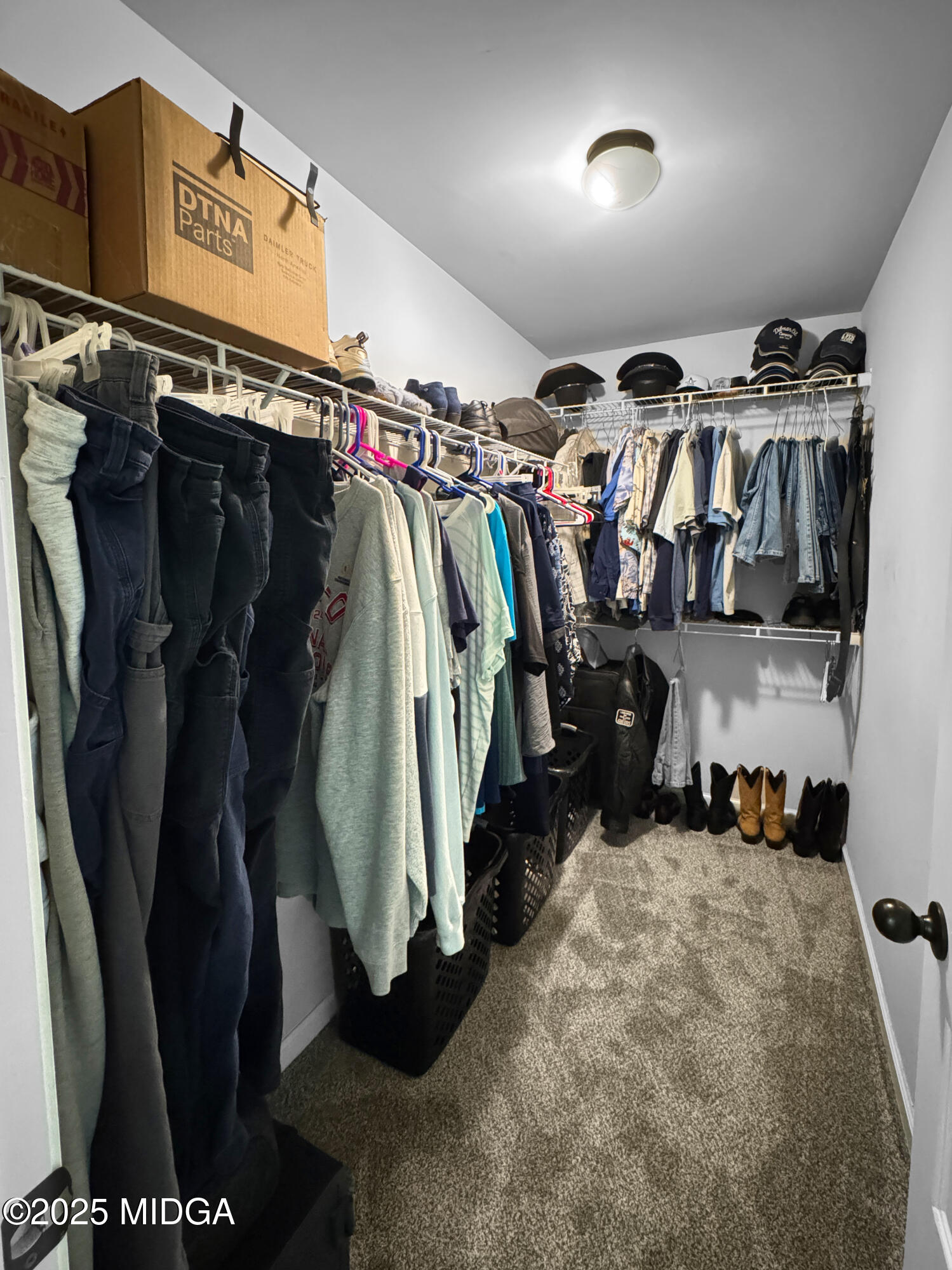 837 Weldon Road Forsyth, GA 31029 - Photo 14 of 24 a view of walk in closet with clothes and shoes