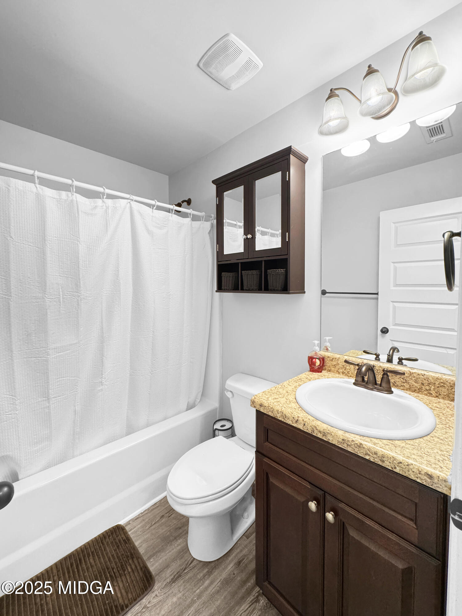 837 Weldon Road Forsyth, GA 31029 - Photo 17 of 24 a bathroom with a sink a toilet and a mirror