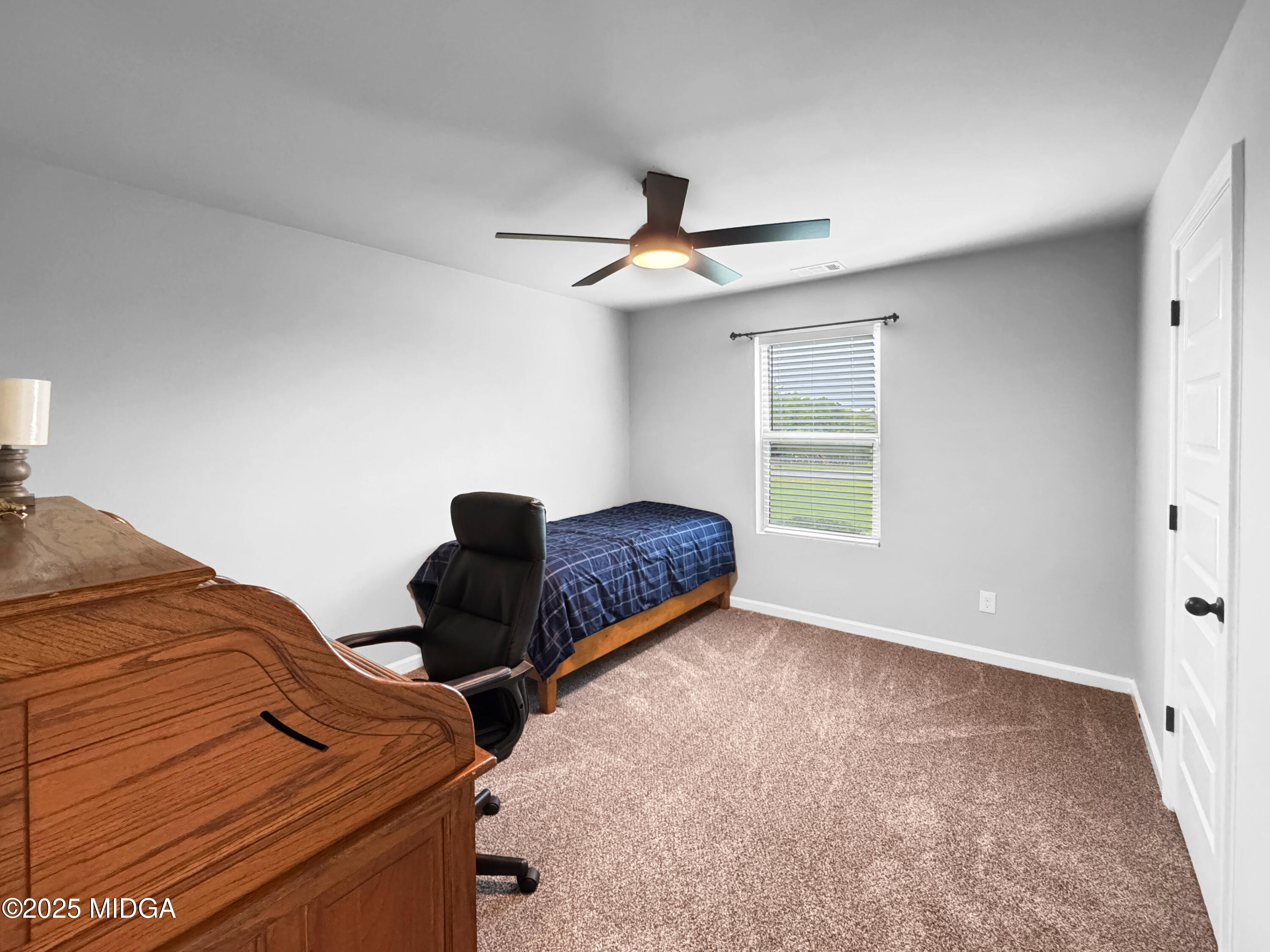 837 Weldon Road Forsyth, GA 31029 - Photo 18 of 24 a bedroom with furniture and a window