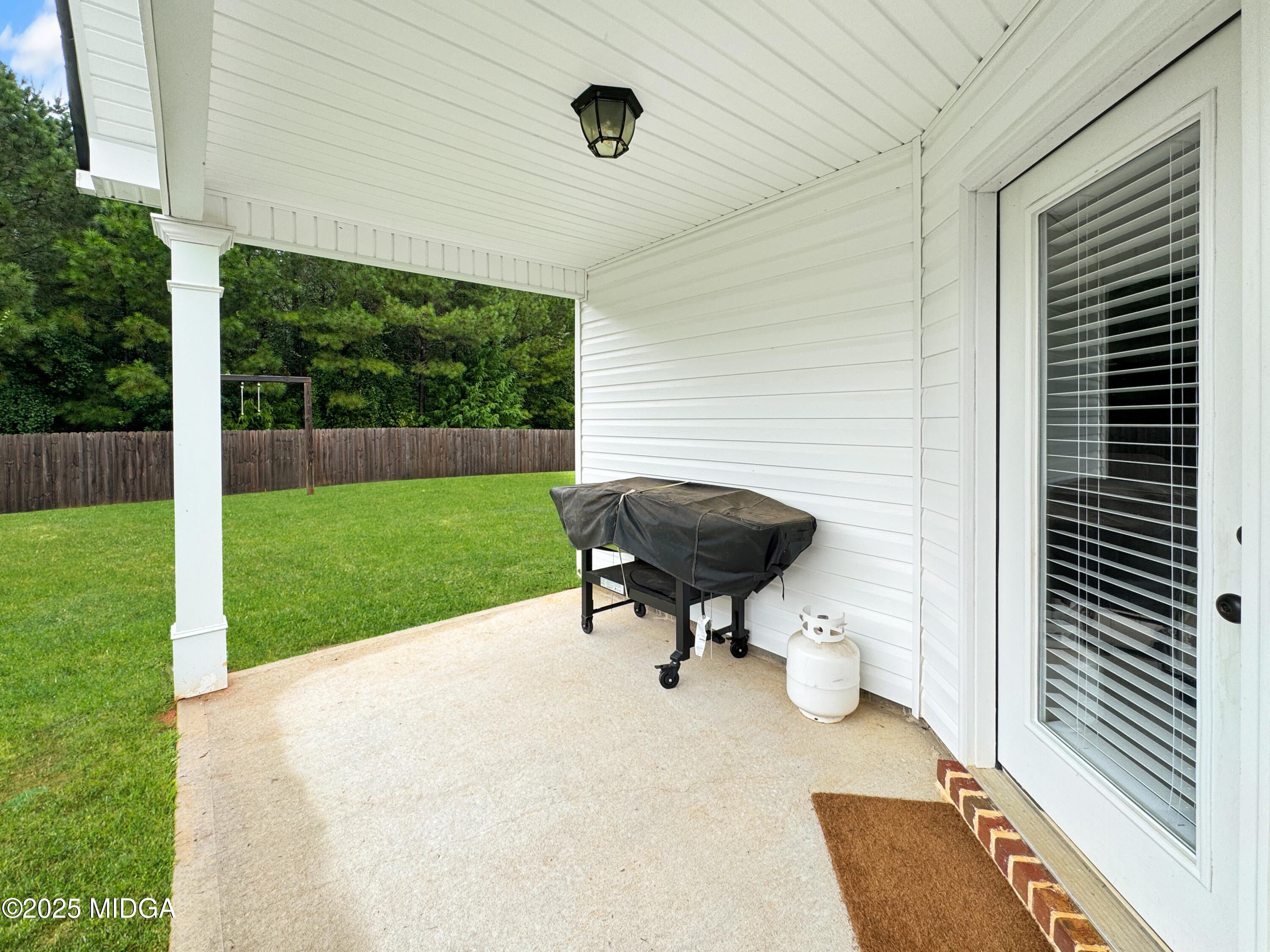837 Weldon Road Forsyth, GA 31029 - Photo 19 of 24 a backyard of a house with table and chairs