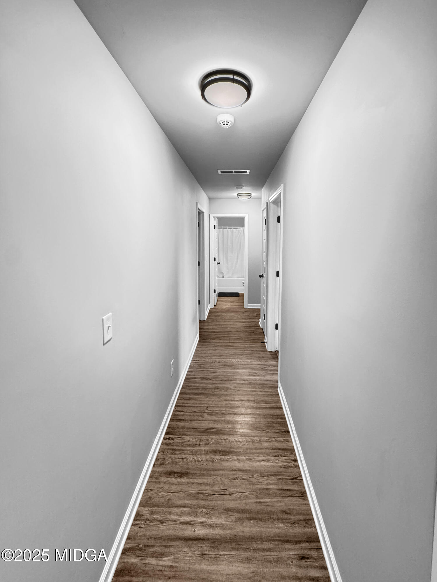 837 Weldon Road Forsyth, GA 31029 - Photo 9 of 24 a view of a hallway with wooden floor and stairs