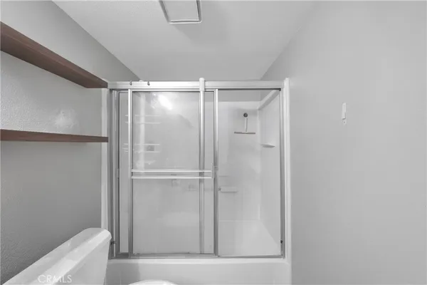 a bathroom with a glass shower door