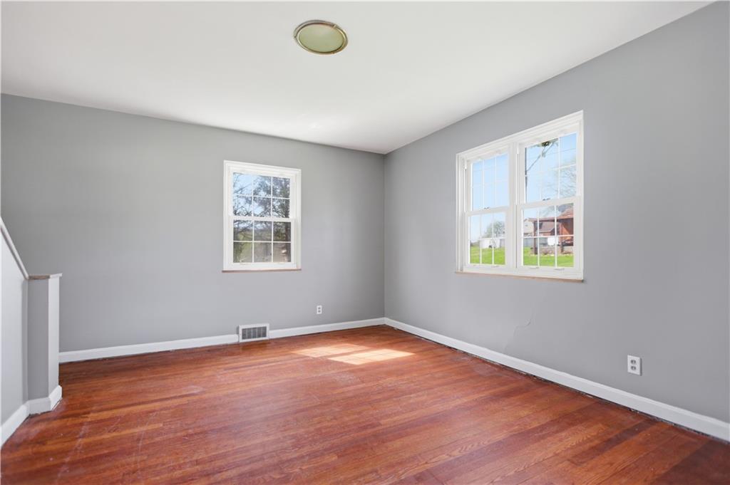 64 Harmon Creek Road Burgettstown, PA 15021 - Photo 6 of 29 an empty room with wooden floor and windows