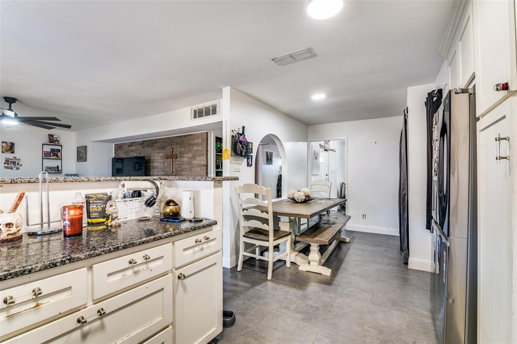 5610 Magnolia Lane Rowlett, TX 75089 - Photo 11 of 25 a kitchen with stainless steel appliances kitchen island granite countertop a refrigerator and microwave