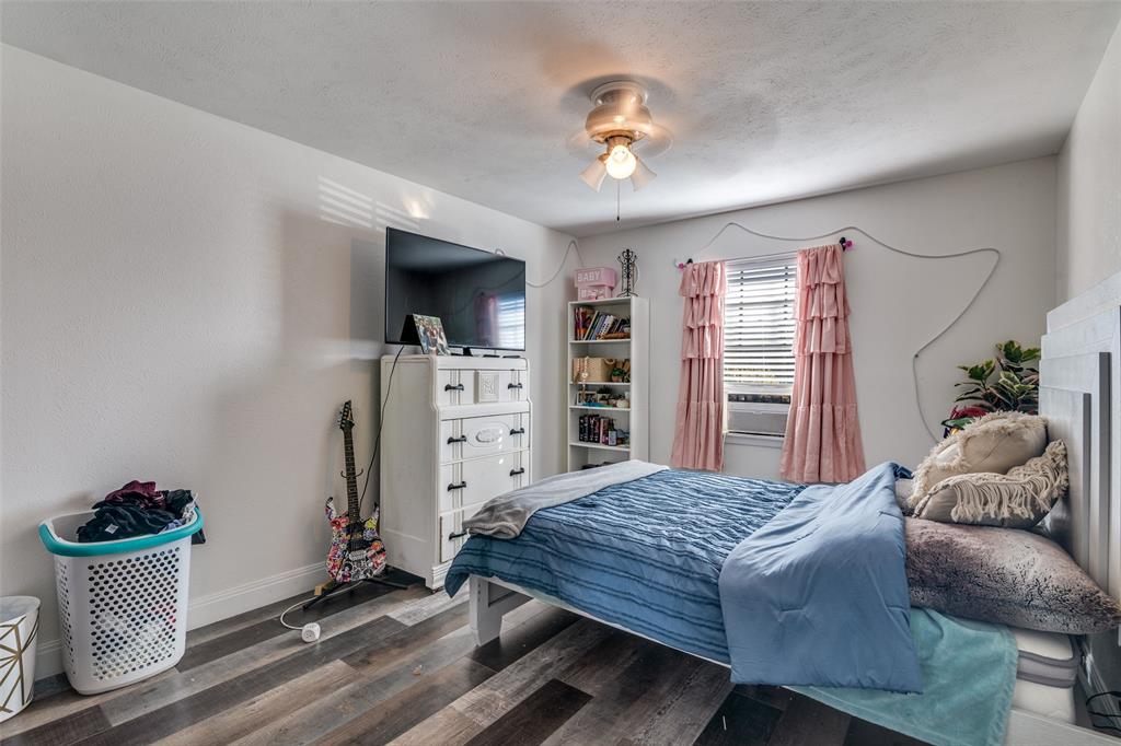 5610 Magnolia Lane Rowlett, TX 75089 - Photo 16 of 25 a bedroom with a bed and a television