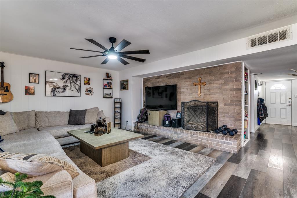 5610 Magnolia Lane Rowlett, TX 75089 - Photo 7 of 25 a living room with furniture and a fireplace