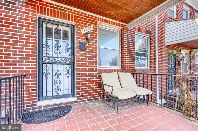 a brick building with a bench and a window