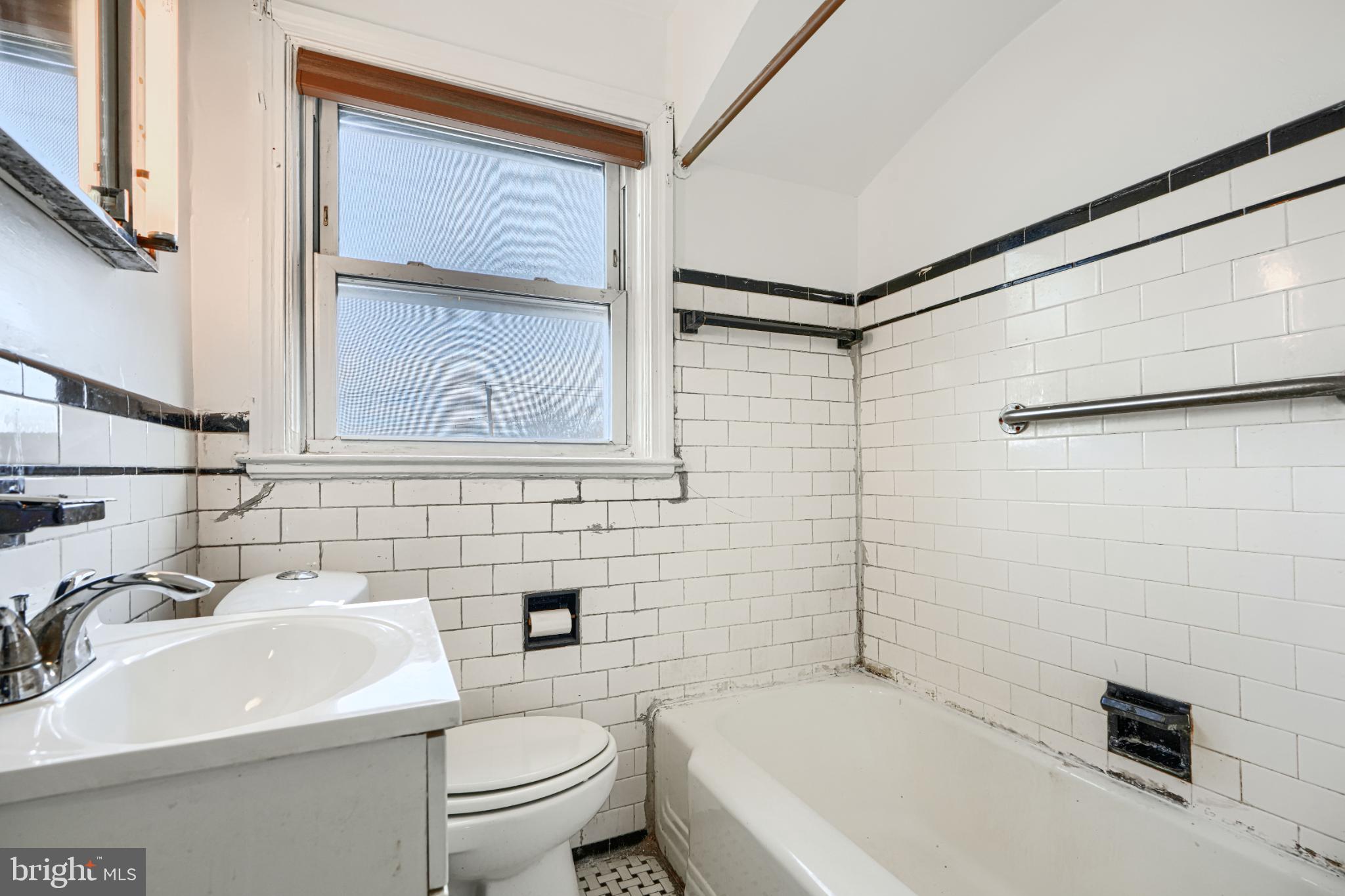 1302 Edison Highway Baltimore, MD 21213 - Photo 19 of 27 a bathroom with a sink a toilet and a bathtub