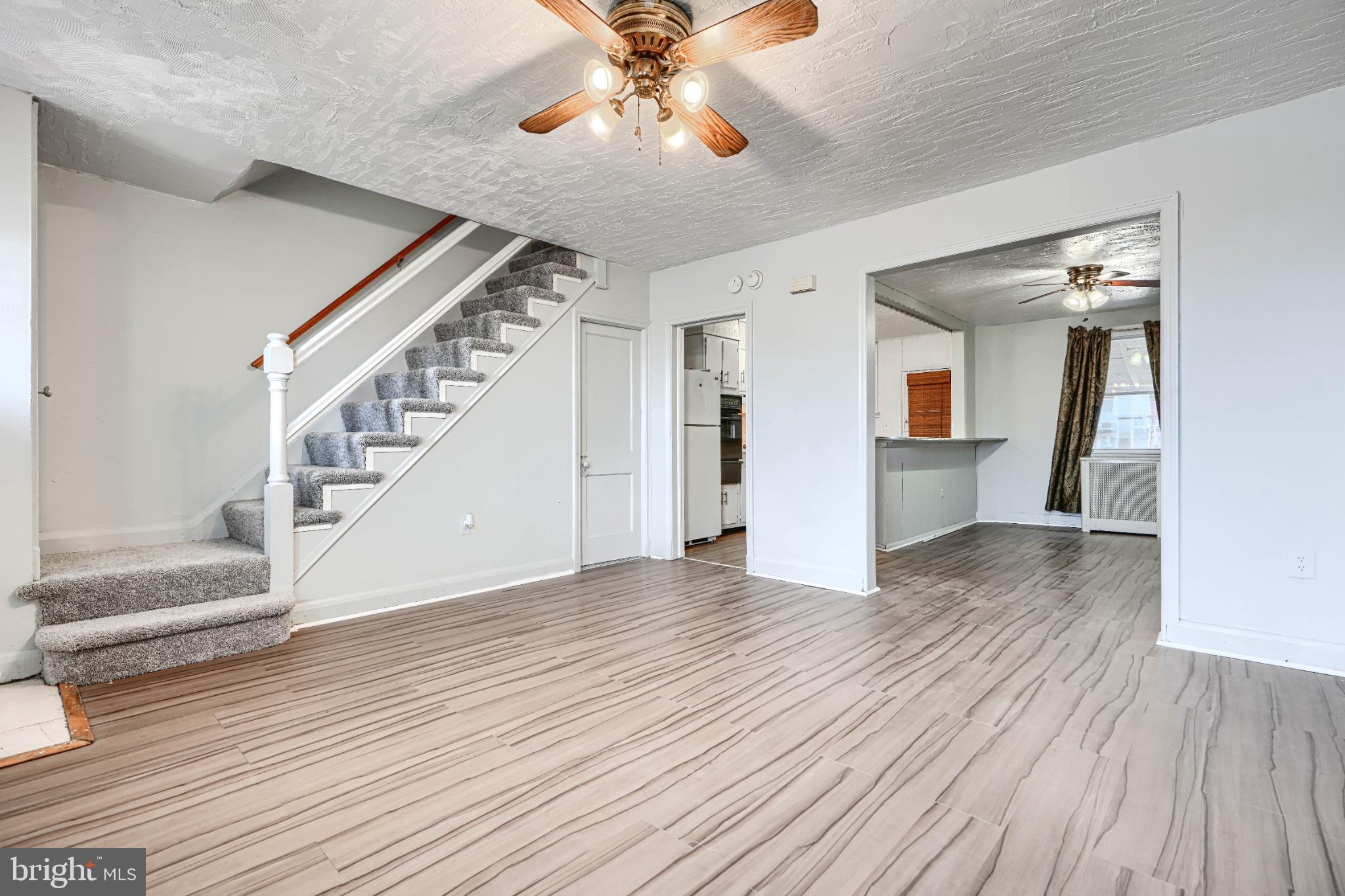1302 Edison Highway Baltimore, MD 21213 - Photo 5 of 27 wooden floor in an empty room with a window