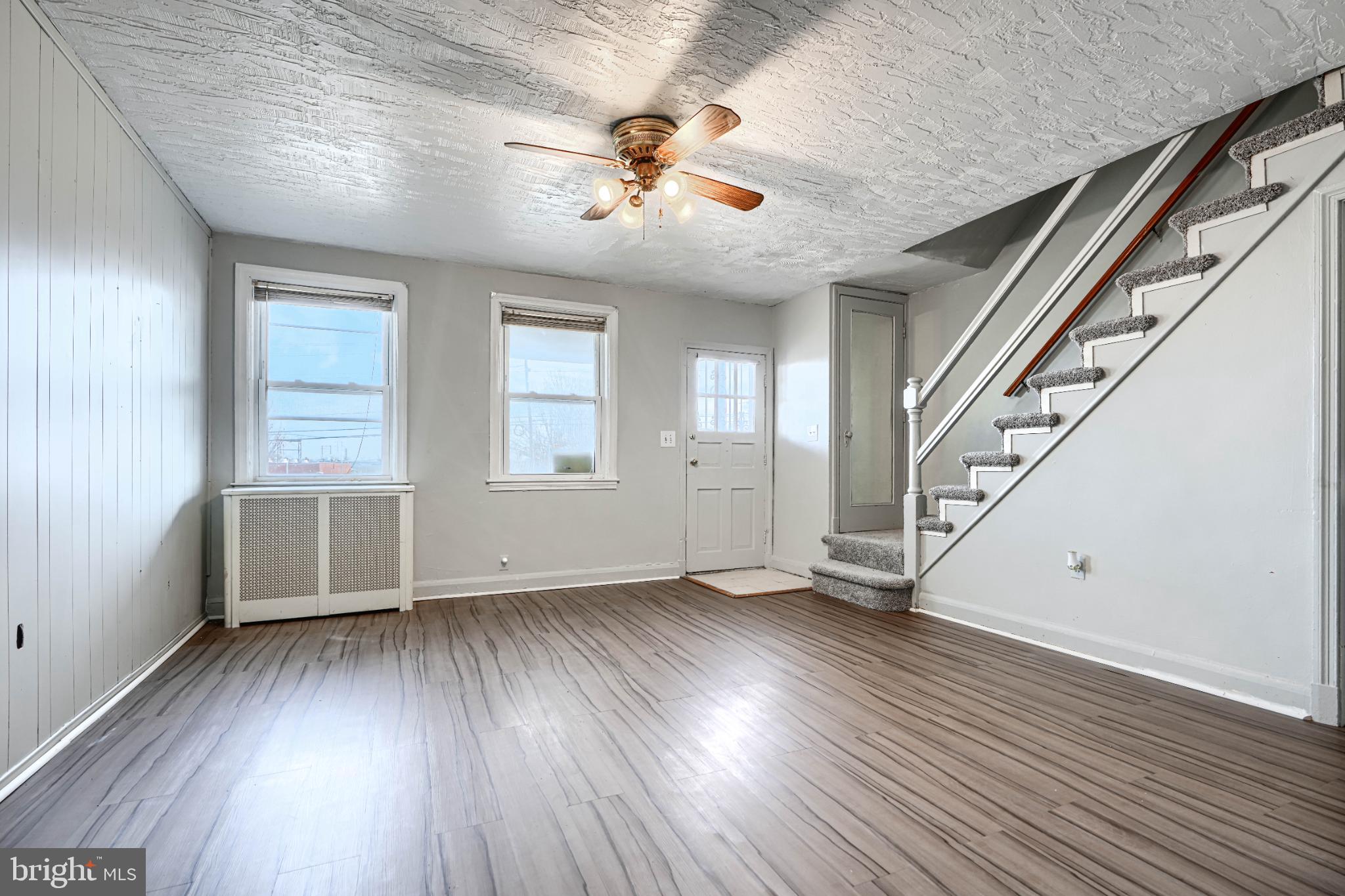 1302 Edison Highway Baltimore, MD 21213 - Photo 6 of 27 wooden floor in an empty room with a window