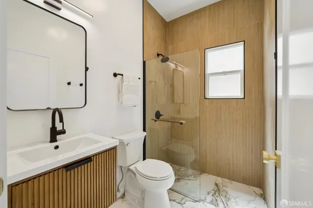 a bathroom with a toilet sink and shower
