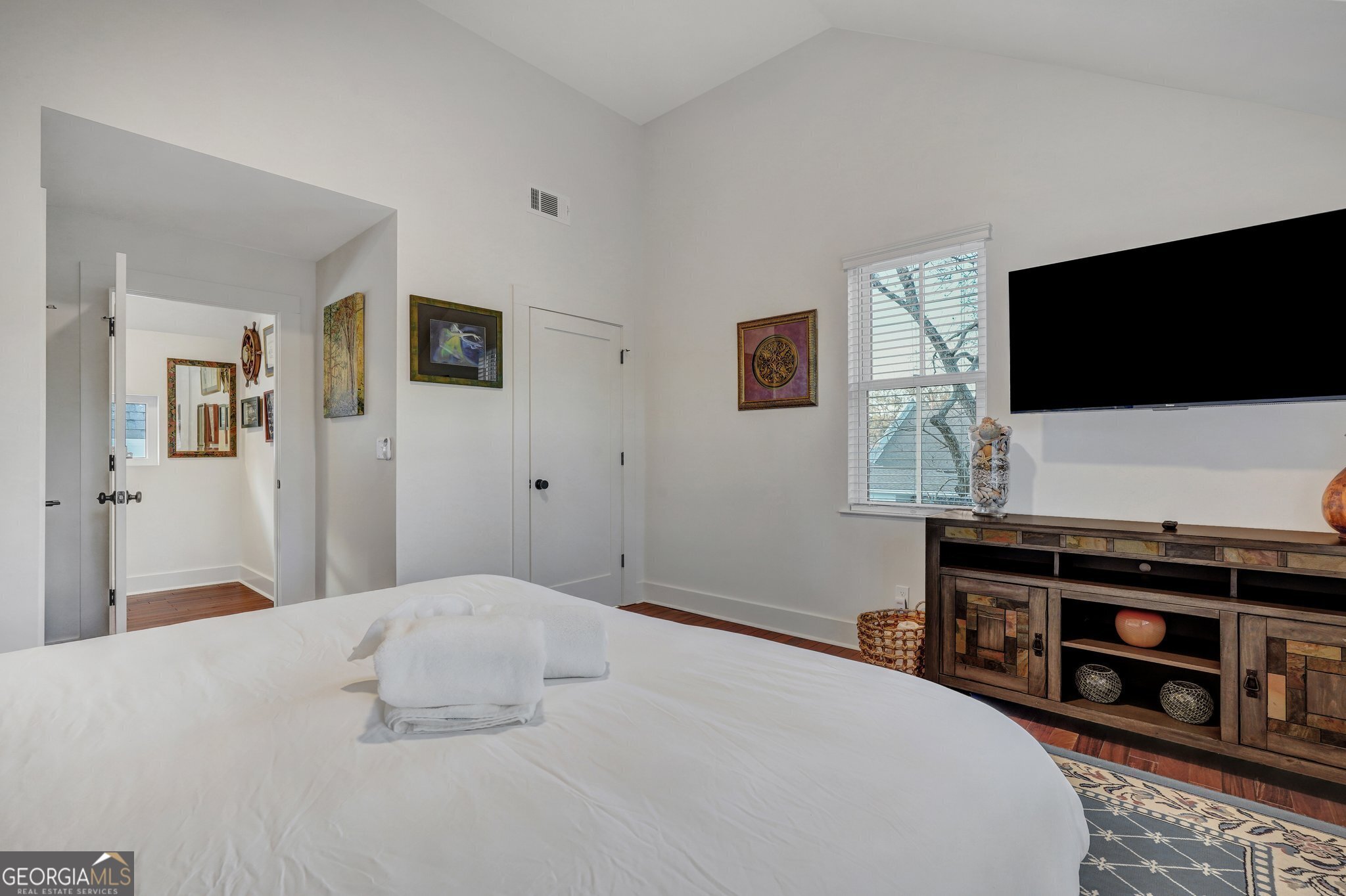 2716 Mechanics Avenue Thunderbolt, GA 31404 - Photo 35 of 50 a bedroom with a flat screen tv and a bed