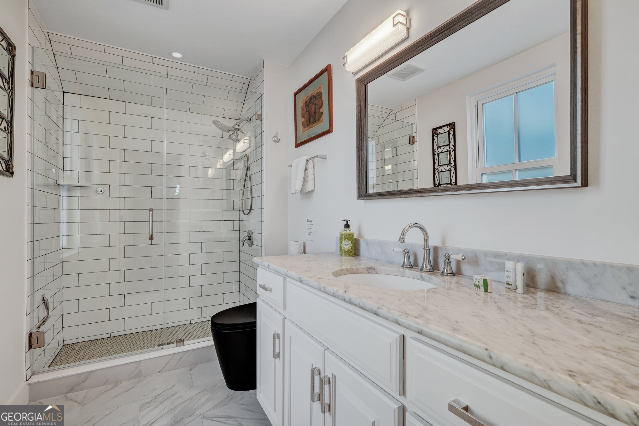 2716 Mechanics Avenue Thunderbolt, GA 31404 - Photo 40 of 50 a bathroom with a granite countertop sink a mirror a bathtub and shower