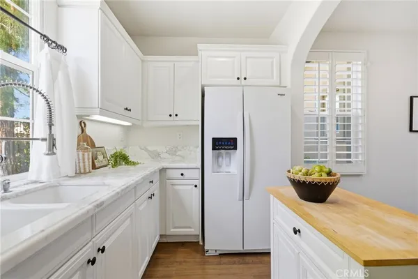 a kitchen with stainless steel appliances cabinets and a window