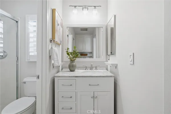 a bathroom with a granite countertop sink vanity and a mirror