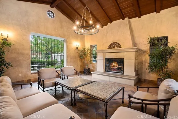 a living room with furniture a window and a fireplace