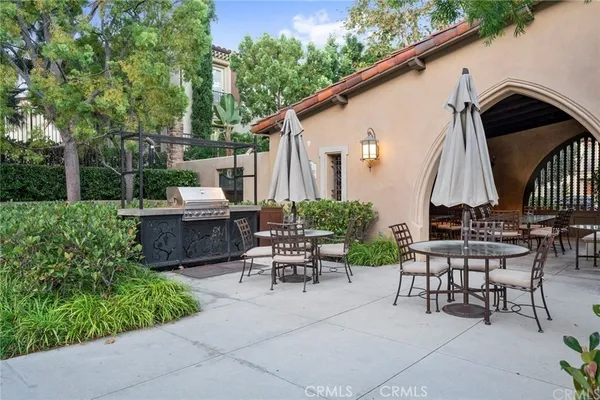 a view of backyard with outdoor seating a patio and plants