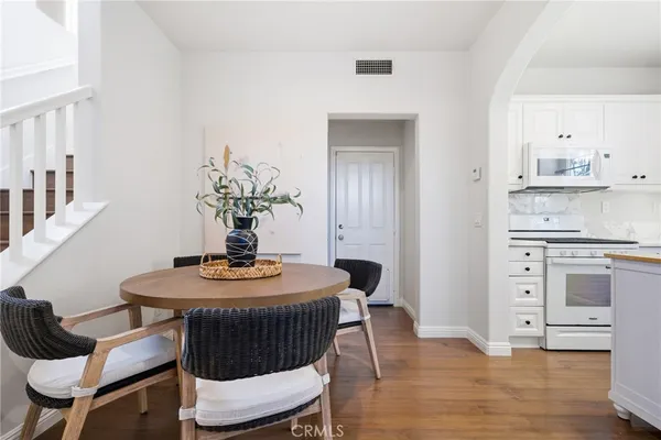 a dining room with furniture and wooden floor